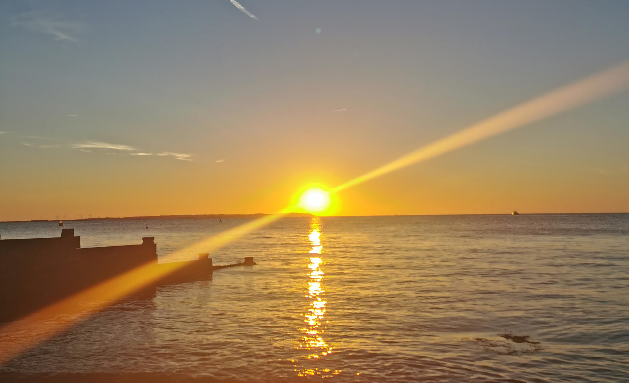 A bright blue sky with small fluffy white clouds across it.